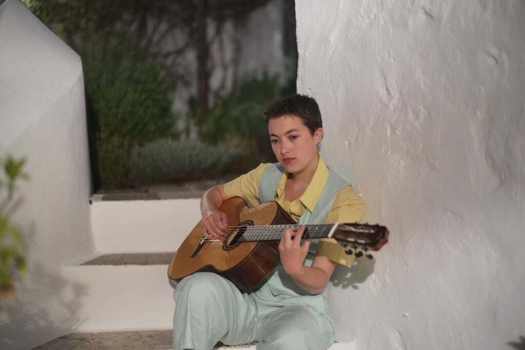 Romany Gilmour playing guitar