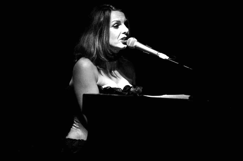 Sam Brown singing at piano